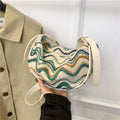 Women's woven straw crossbody bag showing knitted pattern and internal organisation compartments