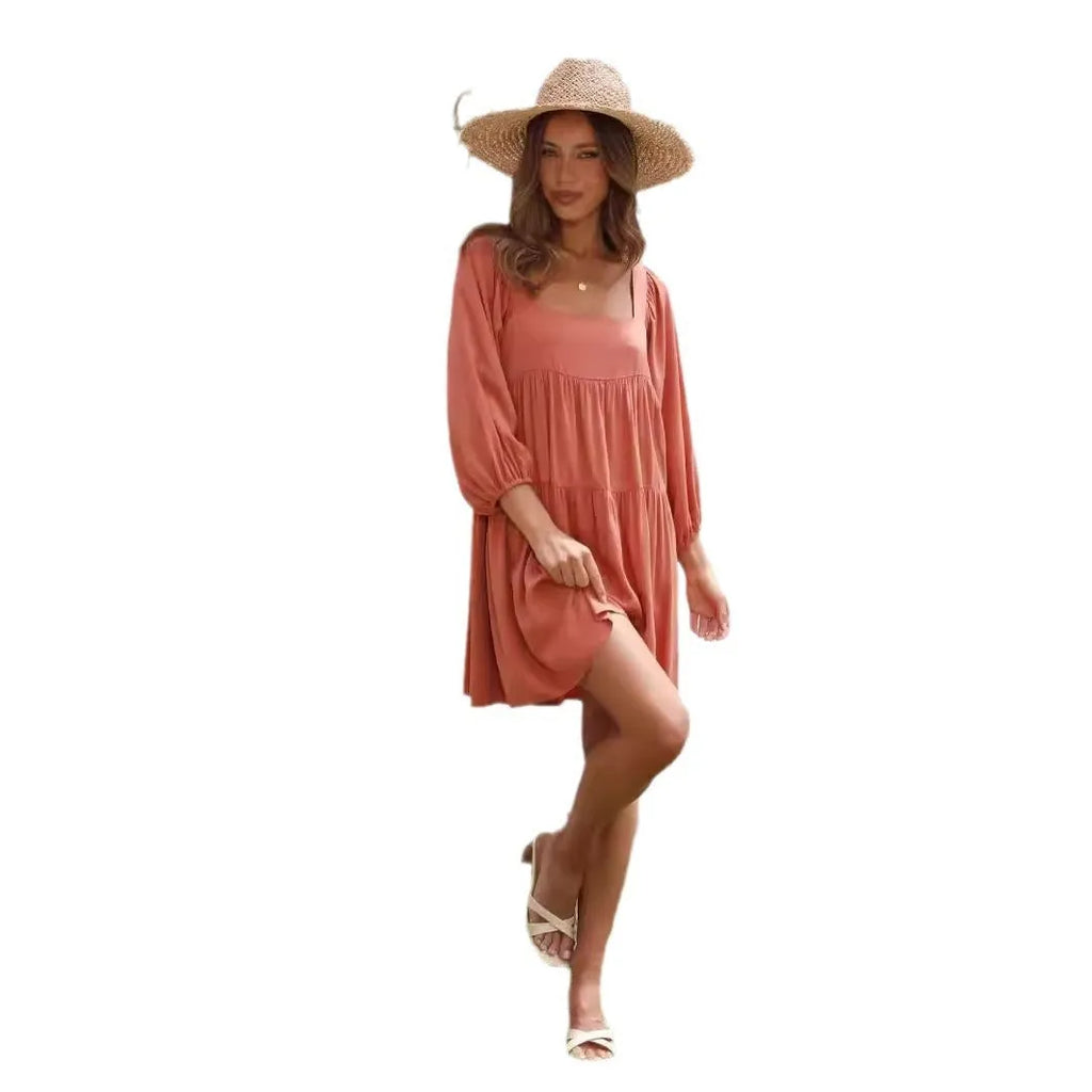 Orange backless A-line dress for a girl with a square collar and puff sleeves.