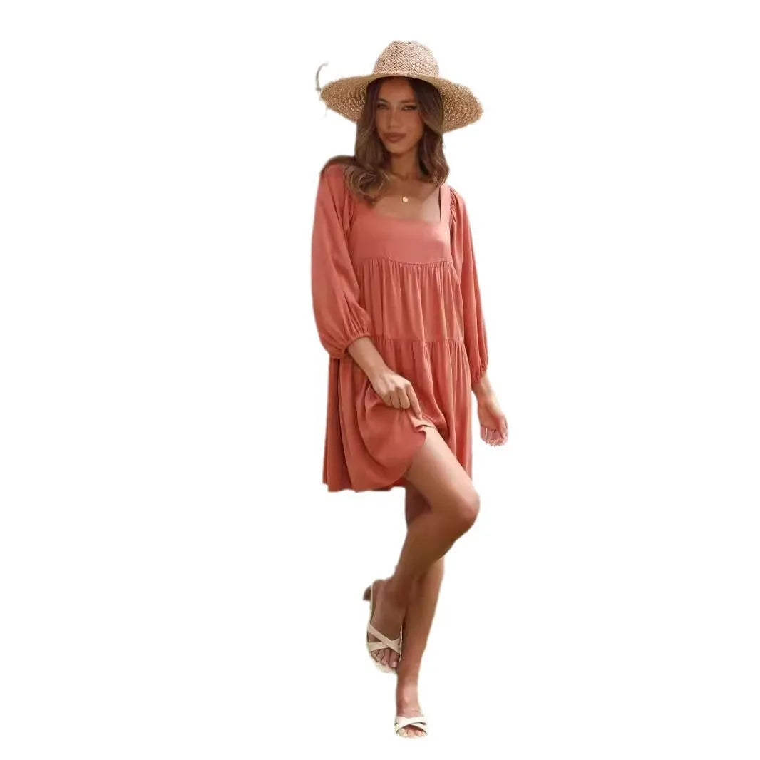 Orange backless A-line dress for a girl with a square collar and puff sleeves.