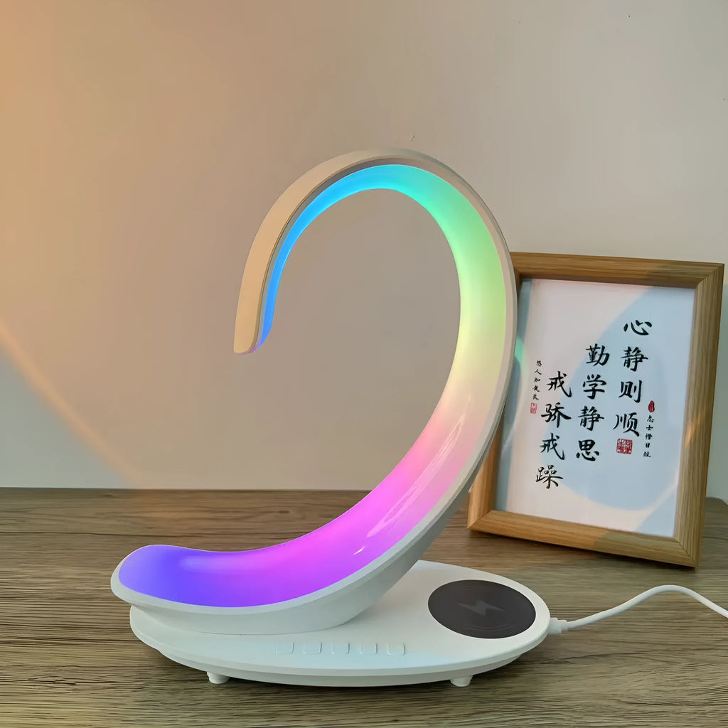 White swan decorative light with wireless charging pad and Bluetooth speaker emitting colourful illumination