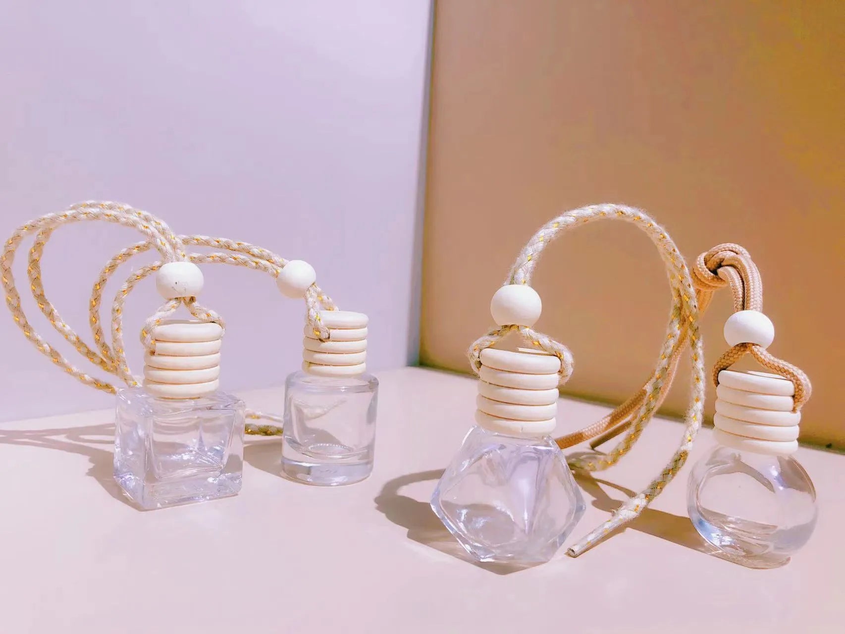 Car perfume pendant in glass bottle showing cylinder, diamond, flat drum and square style options