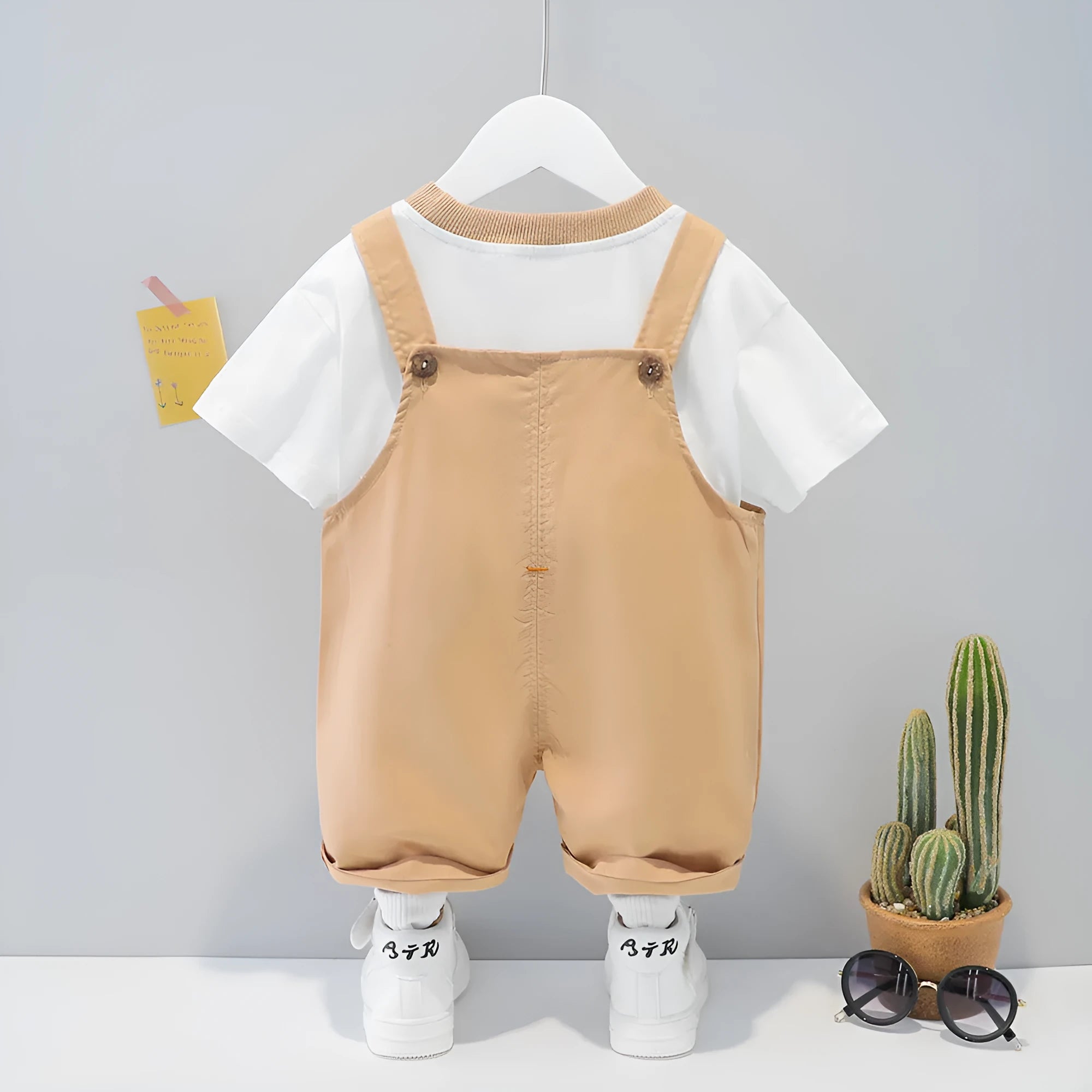 Children's cotton summer overalls with cartoon print in yellow colour showing short sleeves and straps