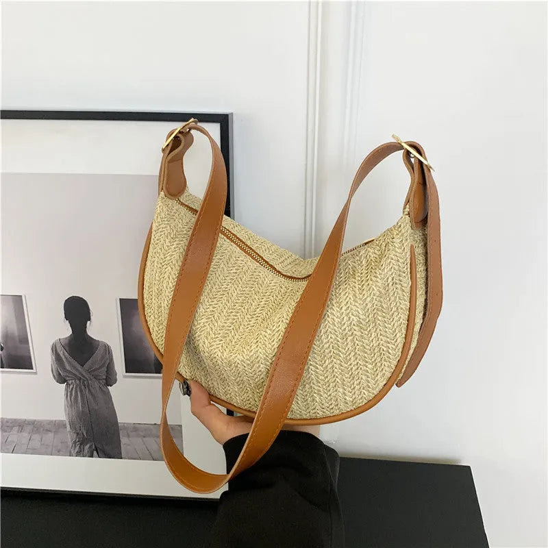 Women's woven straw crossbody bag showing knitted pattern and internal organisation compartments