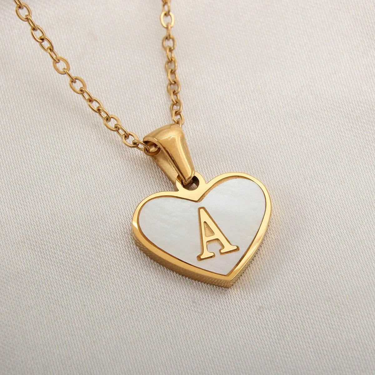 A personalized heart-shaped necklace with a 26-letter charm, crafted from high-quality stainless steel and gold plating.