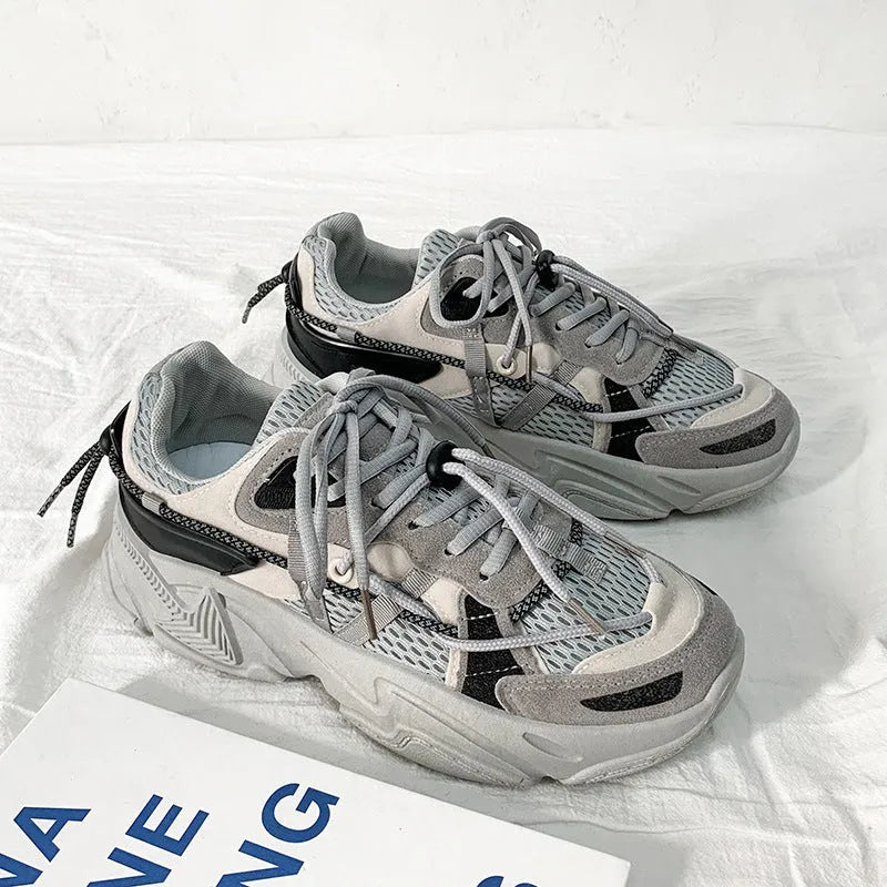 Men's white platform dad shoes with lace-up front and mesh lining on a neutral background.