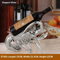 Lobster-shaped resin wine rack in silver or rose gold holding two bottles