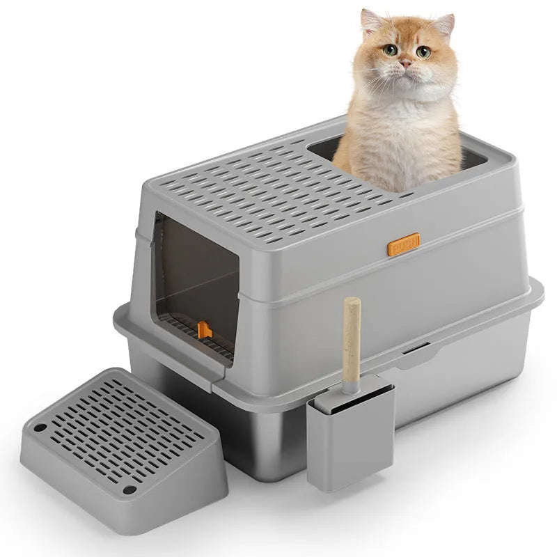 Grey fully enclosed hooded cat litter box with a foot pedal next to the front entrance door.