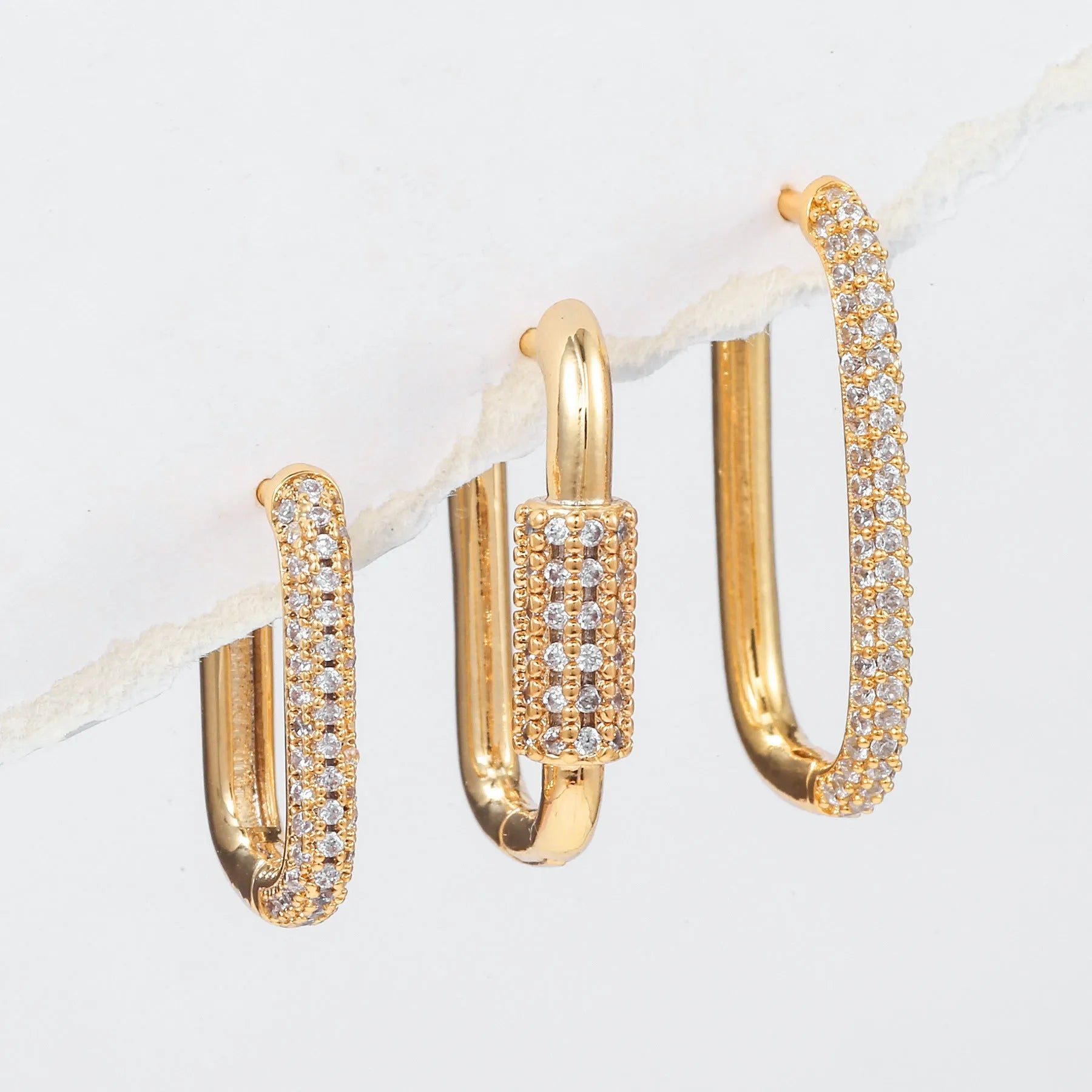 Set of three geometric square clip-on earrings with inlaid zircon detail in gold and white gold tones.