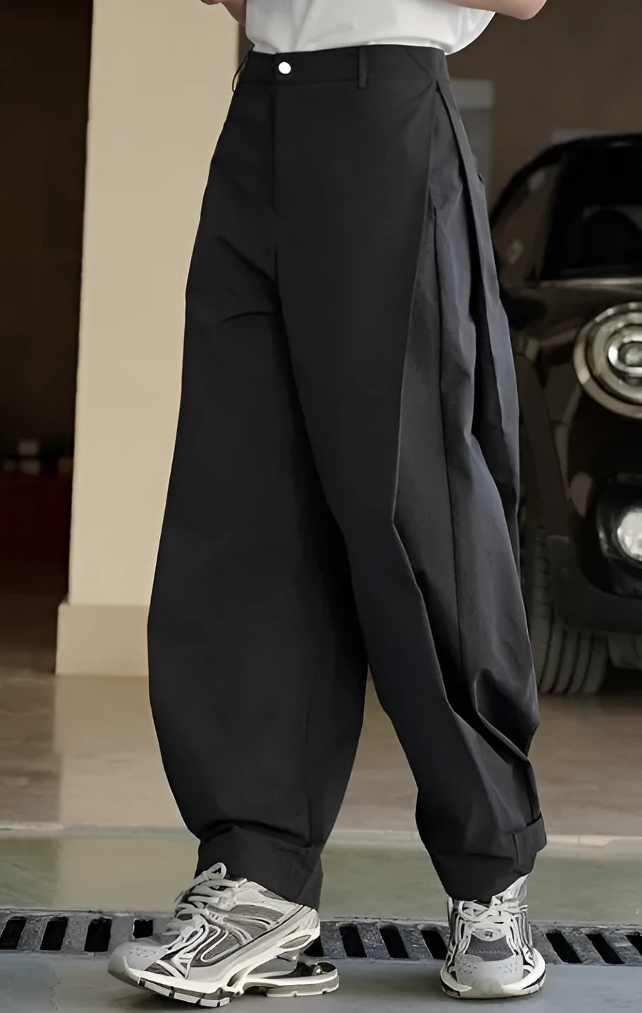 Black high-waisted pleated trousers with loose wide-leg casual design