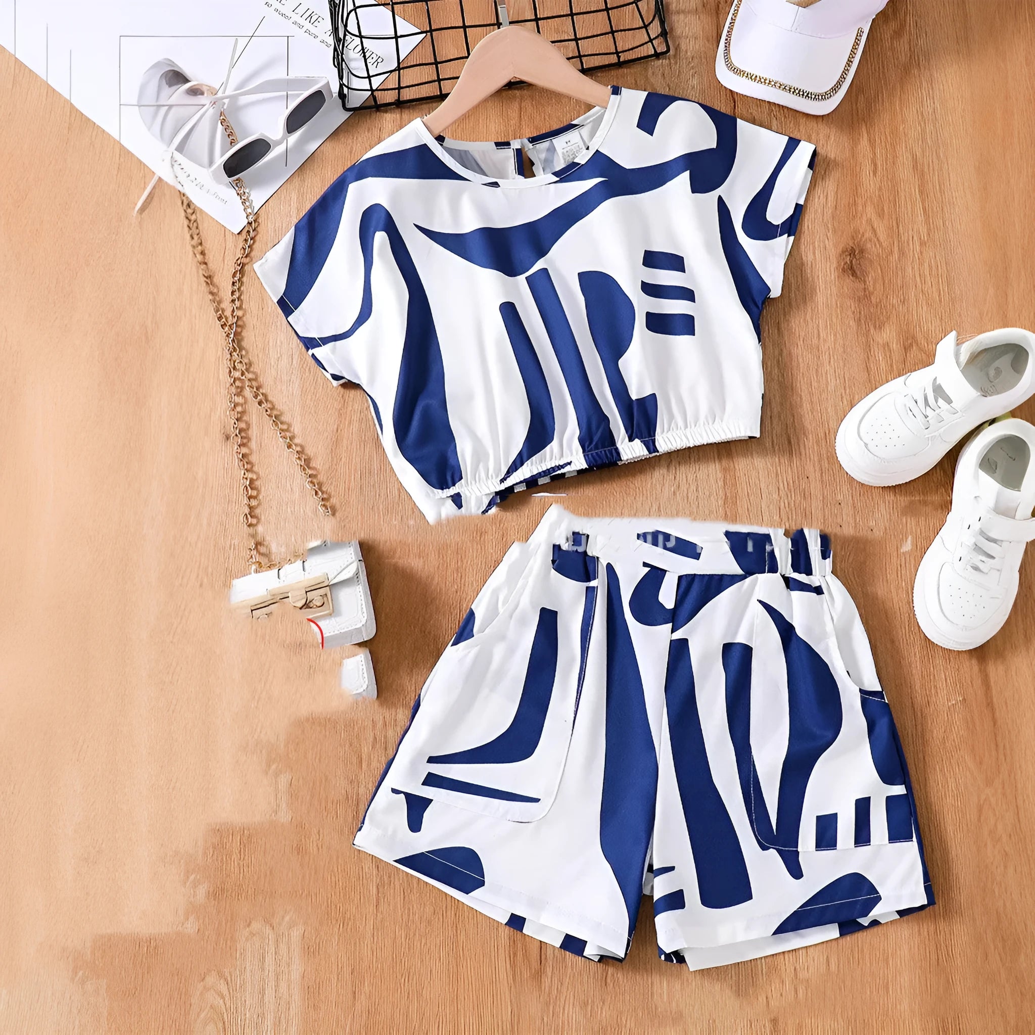 Zebra print short sleeve top and wide leg shorts suit for girls in black and white, side view on hanger