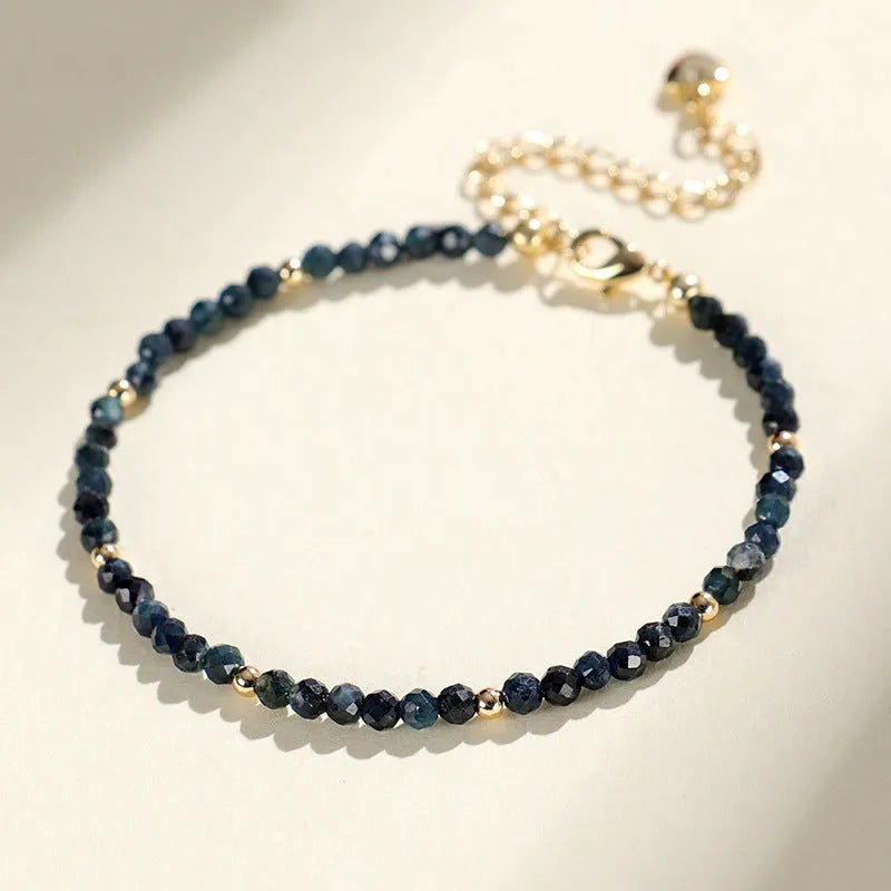 Blue tourmaline beaded bracelet with spacer beads on wrist showing 3mm gemstone size