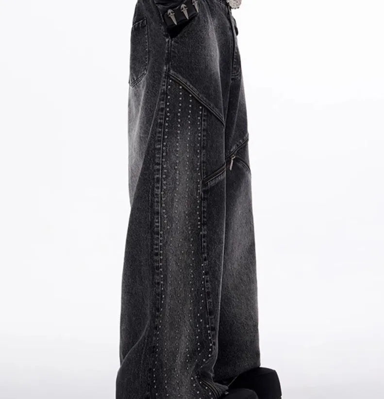 Black and grey washed denim wide leg trousers with structural zipper detail and matching vest, laid flat.