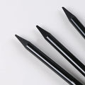Carbonized pencil set showing six graphite and three carbonized drawing pencils with wooden casings on suction card packaging