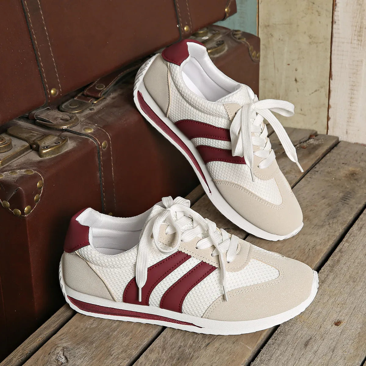 Wine red Cortez retro sneaker with cross strap and breathable mesh surface.