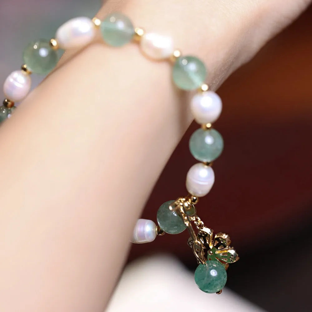 Green freshwater pearl bracelet with Chinese knot design and strawberry pearl hanging detail