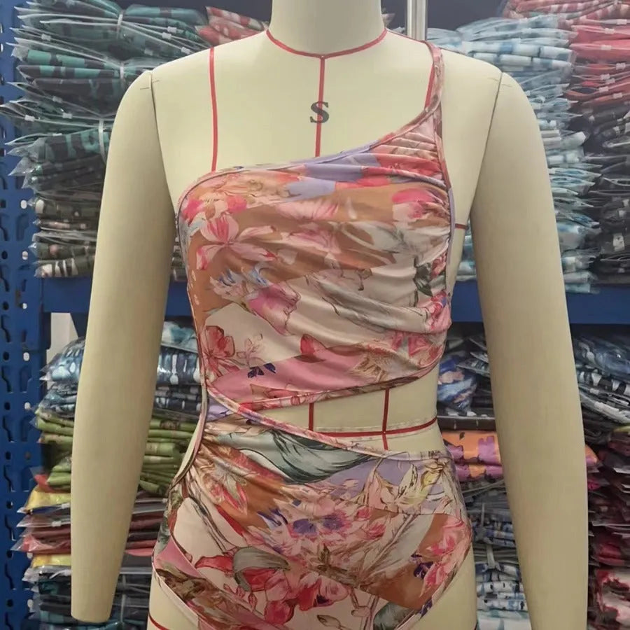 Rose gold patterned women's one-piece swimsuit on a hanger.