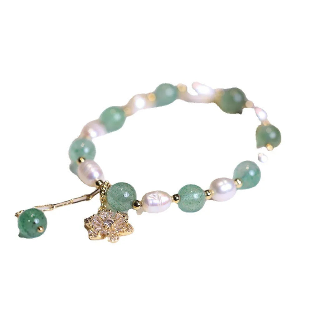 Green freshwater pearl bracelet with Chinese knot design and strawberry pearl hanging detail