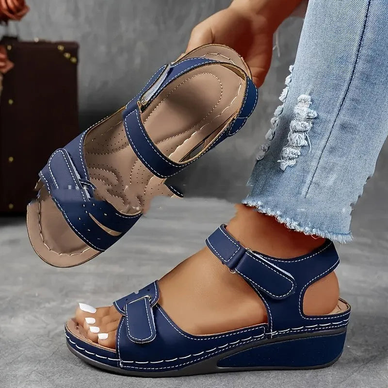 Women's beige plus size sandals with a thick composite sole and an adjustable Velcro strap fastener.