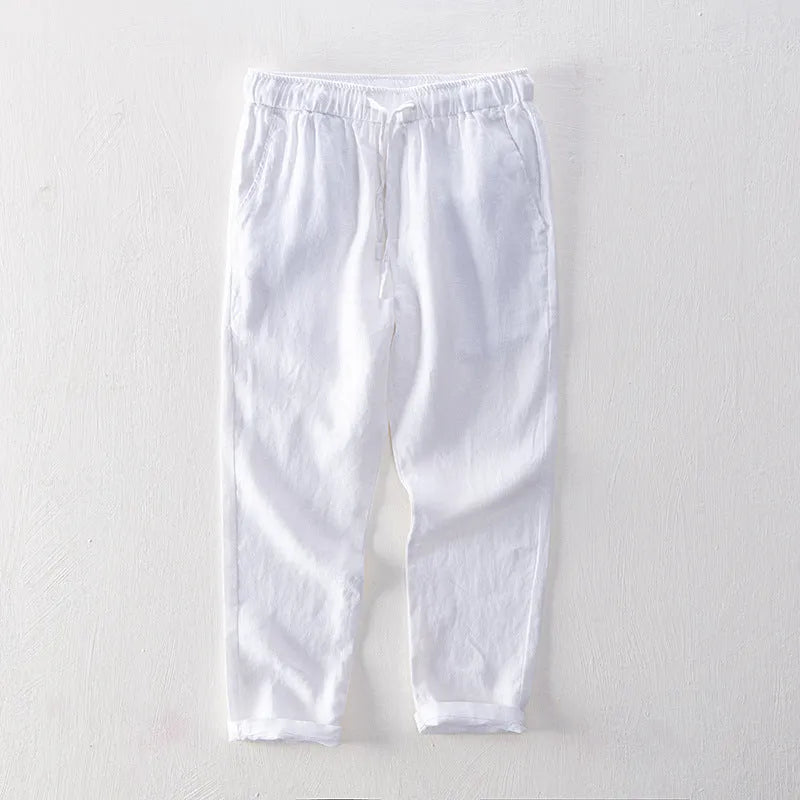 Men's straight leg linen trousers in dark grey, shown laid flat.
