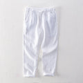 Men's straight leg linen trousers in dark grey, shown laid flat.