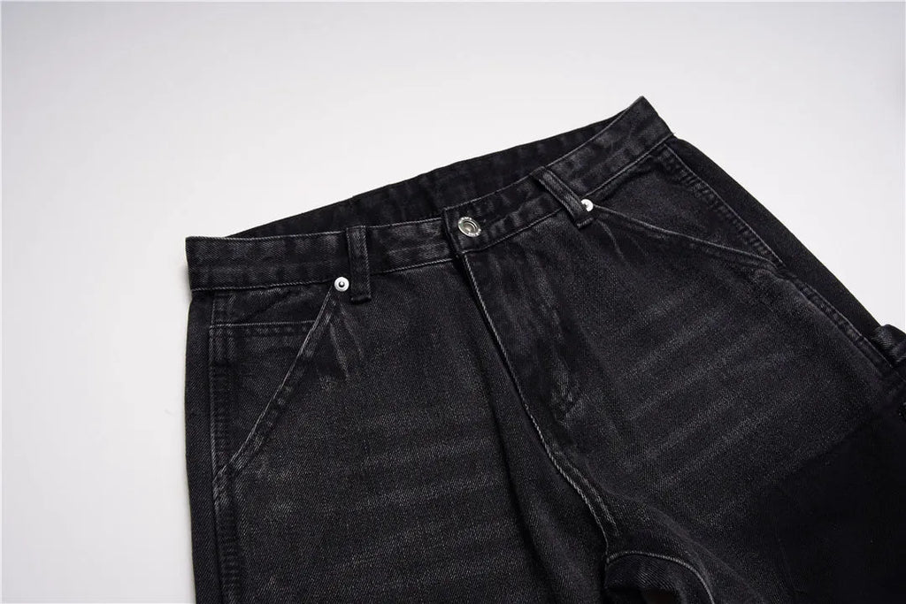 Women's micro flared patchwork raw edge jeans in black denim with loose straight tube fit, front view