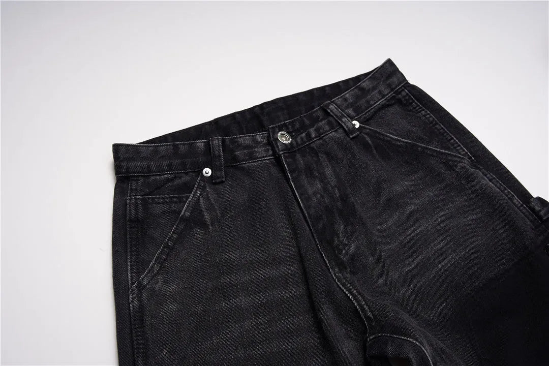 Women's micro flared patchwork raw edge jeans in black denim with loose straight tube fit, front view