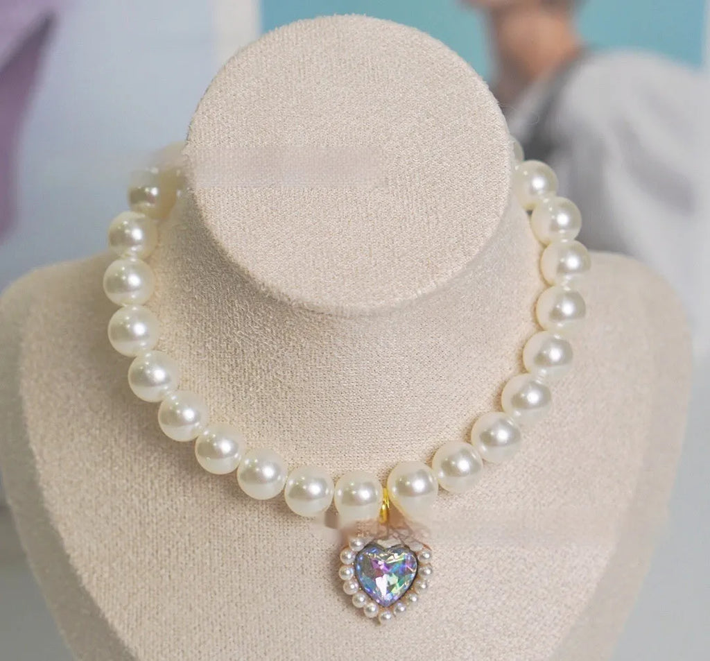 A decorative gem-style cat collar in plastic alloy resin, shown in multiple solid colours with adjustable sizing.