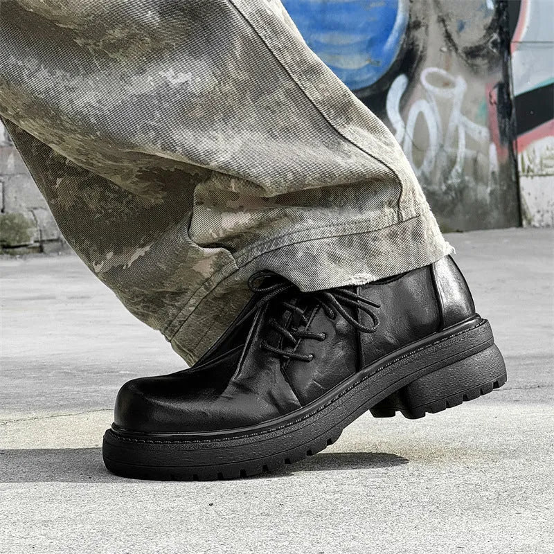Black leather platform shoes with warped head design and rubber sole