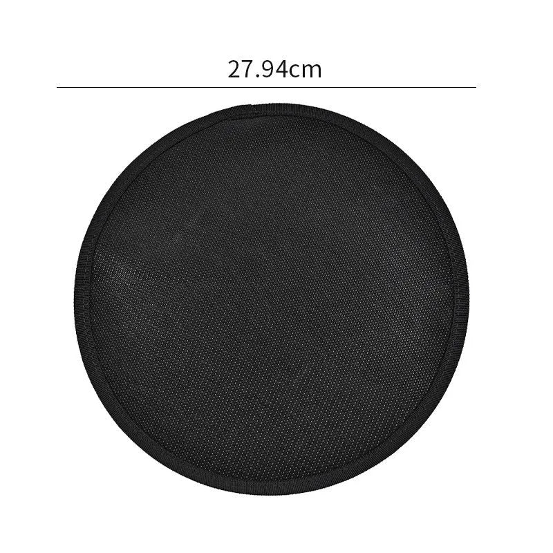 Black round barbecue fireproof mat with oil-resistant surface on a garden patio