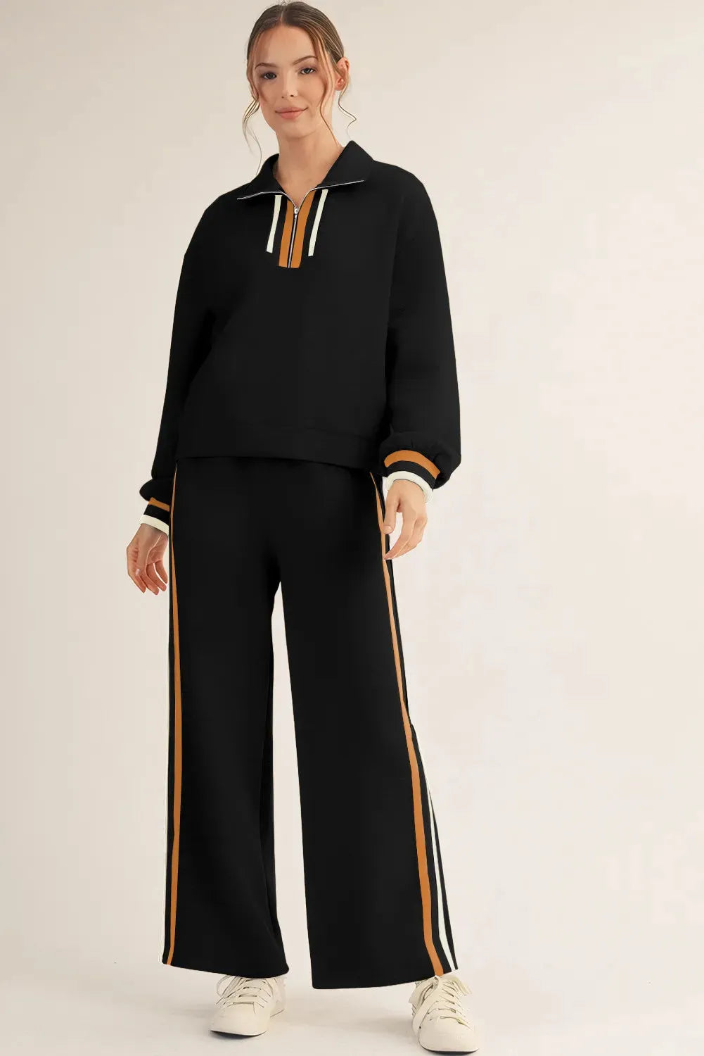 Black striped patchwork quarter zip pullover and loose pant set for women, two-piece outfit in polyester viscose elastane blend.