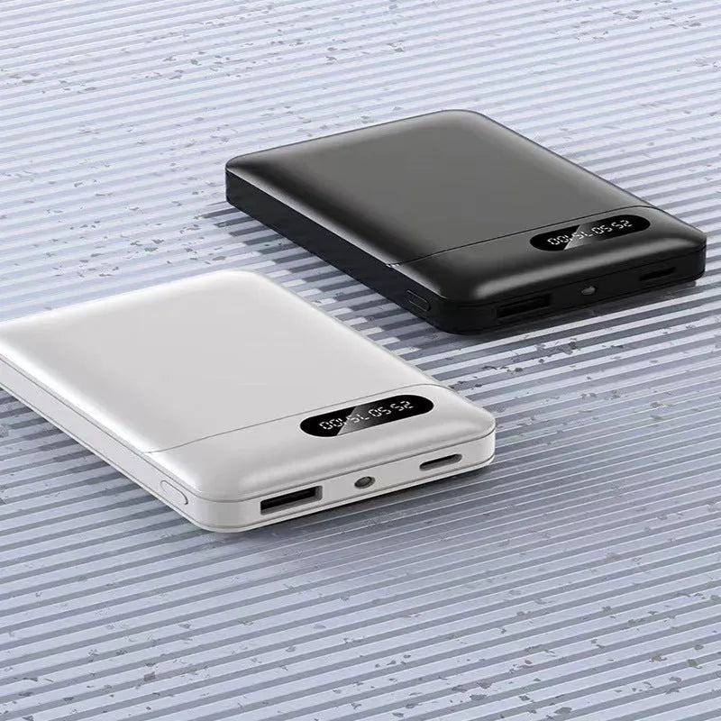 White or black plastic portable power bank with USB ports showing dimensions 92mm x 63mm x 23mm