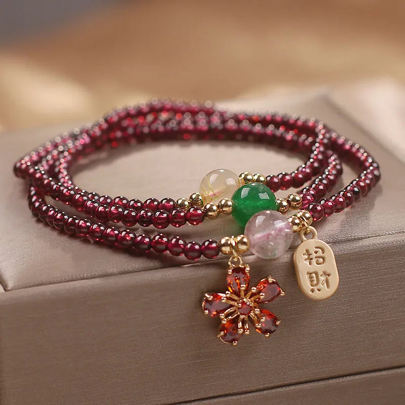Crystal bracelet for women in pomegranate red cherry blossom colour with sequin details.