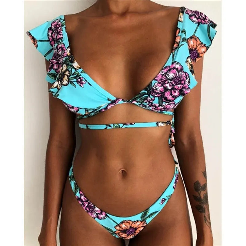 Yellow floral print split bikini swimsuit on a hanger, showing top and briefs.