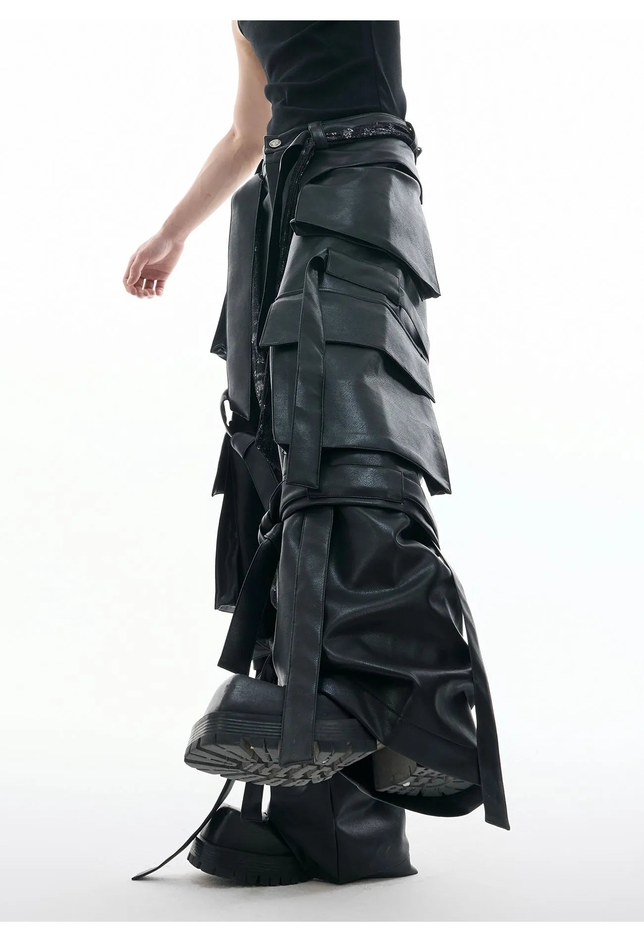 Black loose fit trousers with multi-pocket stitching and ribbon leather detailing on heavy composite fabric
