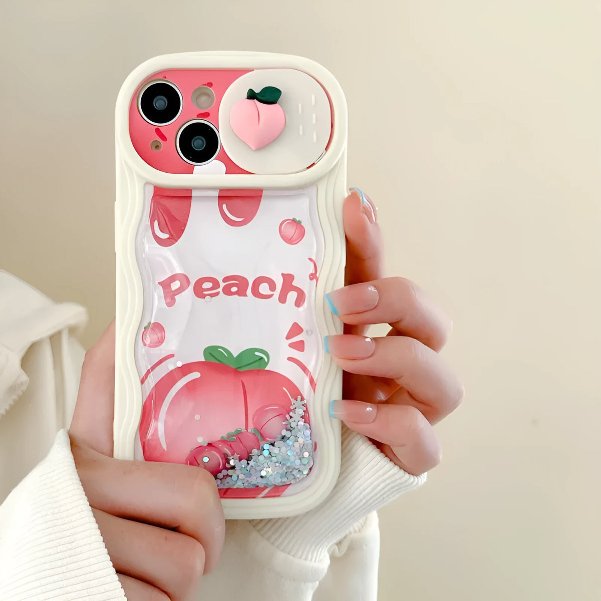 Fruit style quicksand phone case in quicksand peach, all-inclusive TPU design for iPhone, fall protection, cartoon elements.