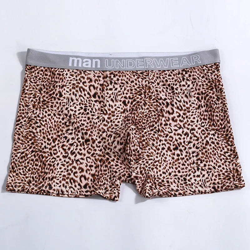 Men's loose fit leopard print boxer shorts showing mid-waist design and polyester knit fabric texture