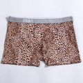 Men's loose fit leopard print boxer shorts showing mid-waist design and polyester knit fabric texture