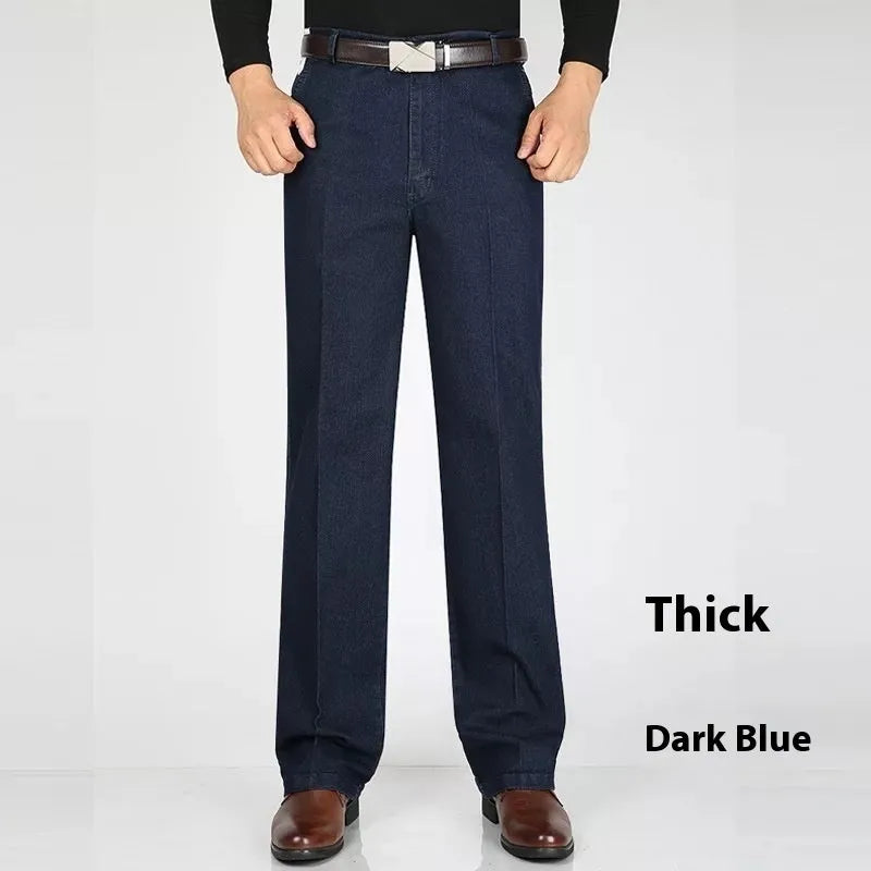 Men's loose fit high waist blue denim jeans on a plain background.
