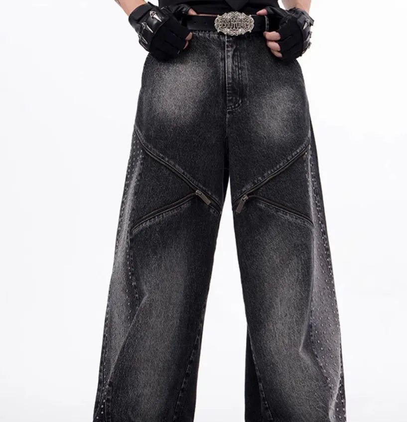 Black and grey washed denim wide leg trousers with structural zipper detail and matching vest, laid flat.