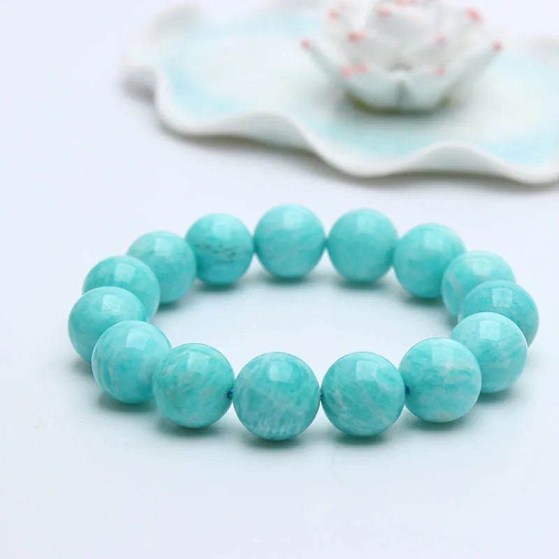 Natural blue-green amazonite gemstone beaded bracelet with stainless steel clasp on a wrist.