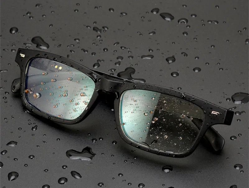 Smart glasses with semi-open Bluetooth audio speakers on temples and dark UV400 protective lenses.