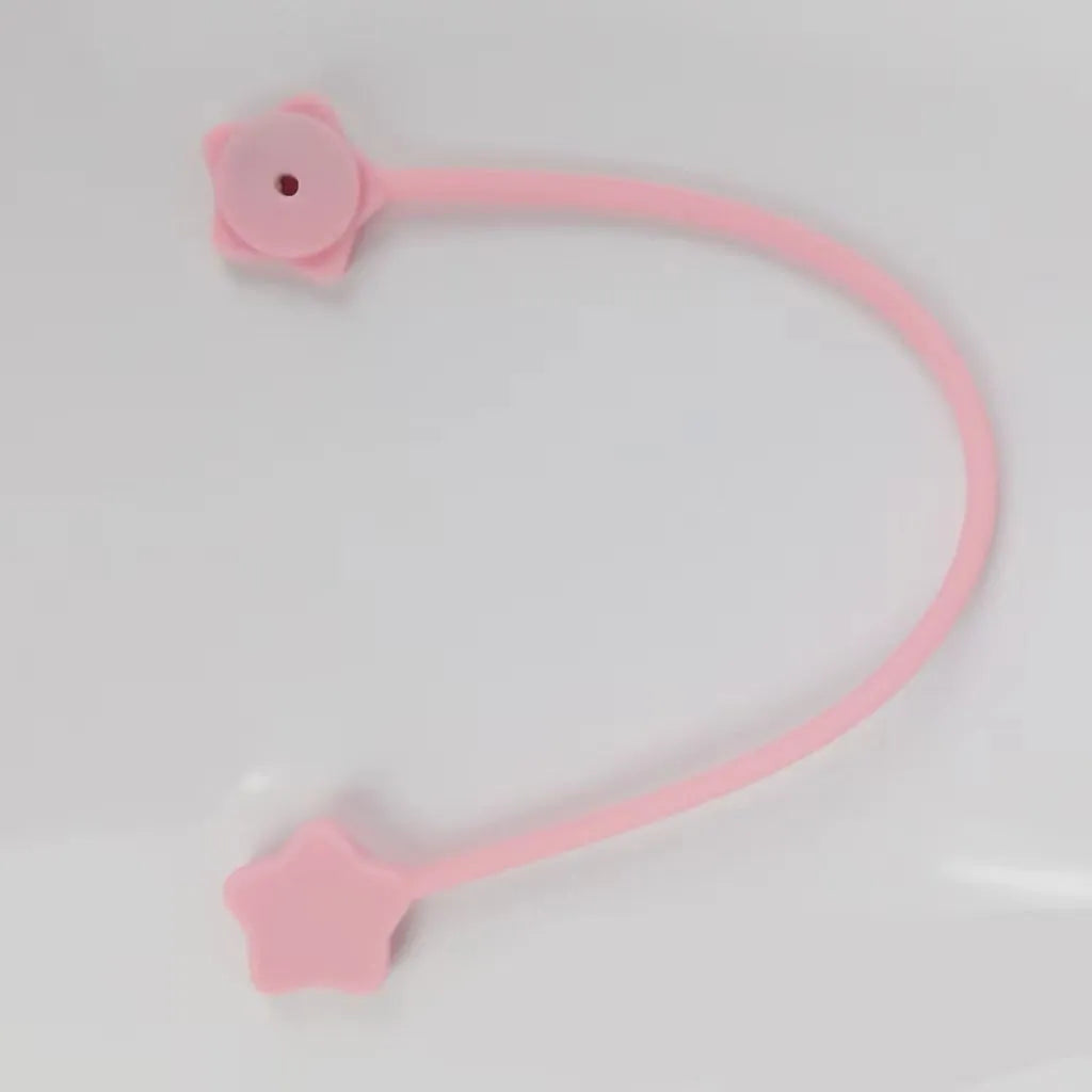 Purple silicone wire winder with magnet for organising headphone and computer cables.