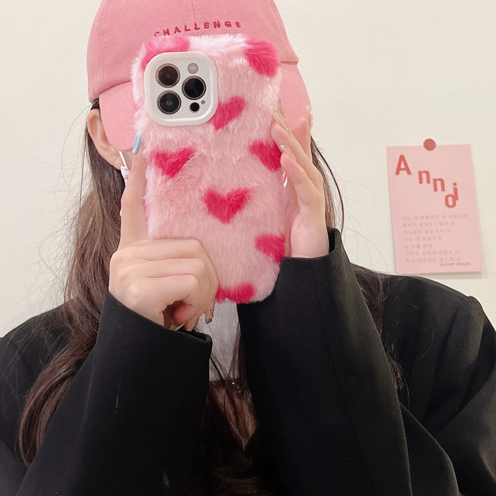 Pink silicone iPhone case with a cartoon design on the back.