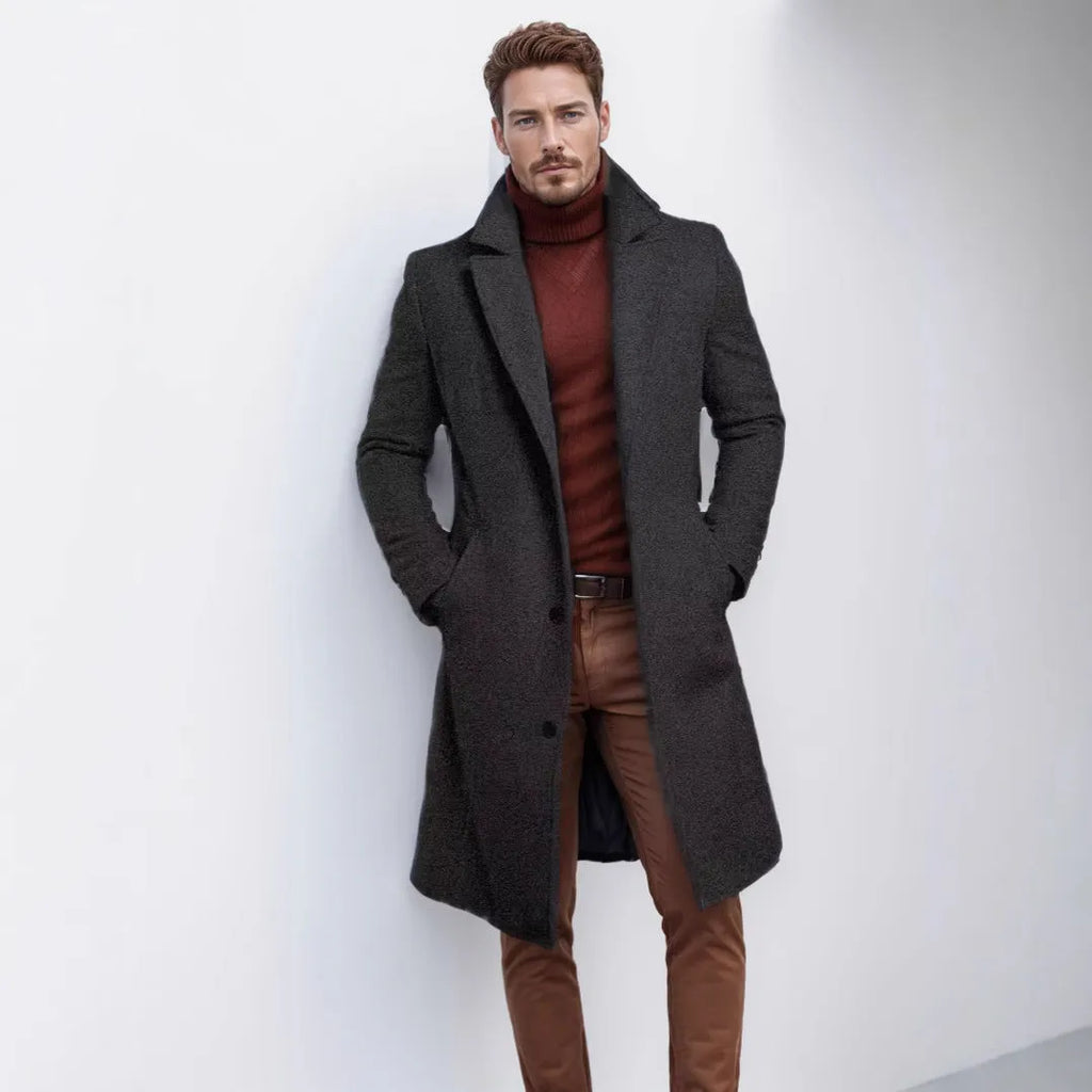 Men's mid-length solid colour woolen coat in dark gray, side view, showing thick fabric and side seam pocket.