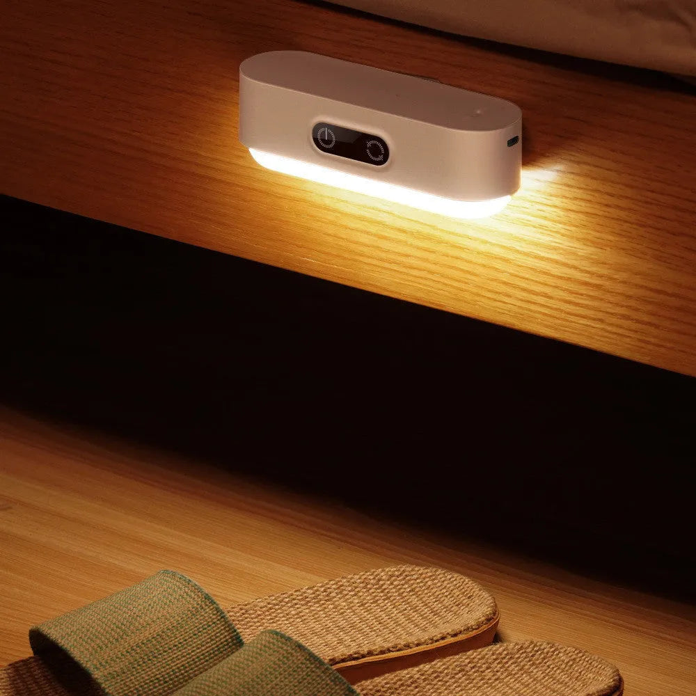 White magnetic USB rechargeable LED sensor light with touch controls on a curved panel
