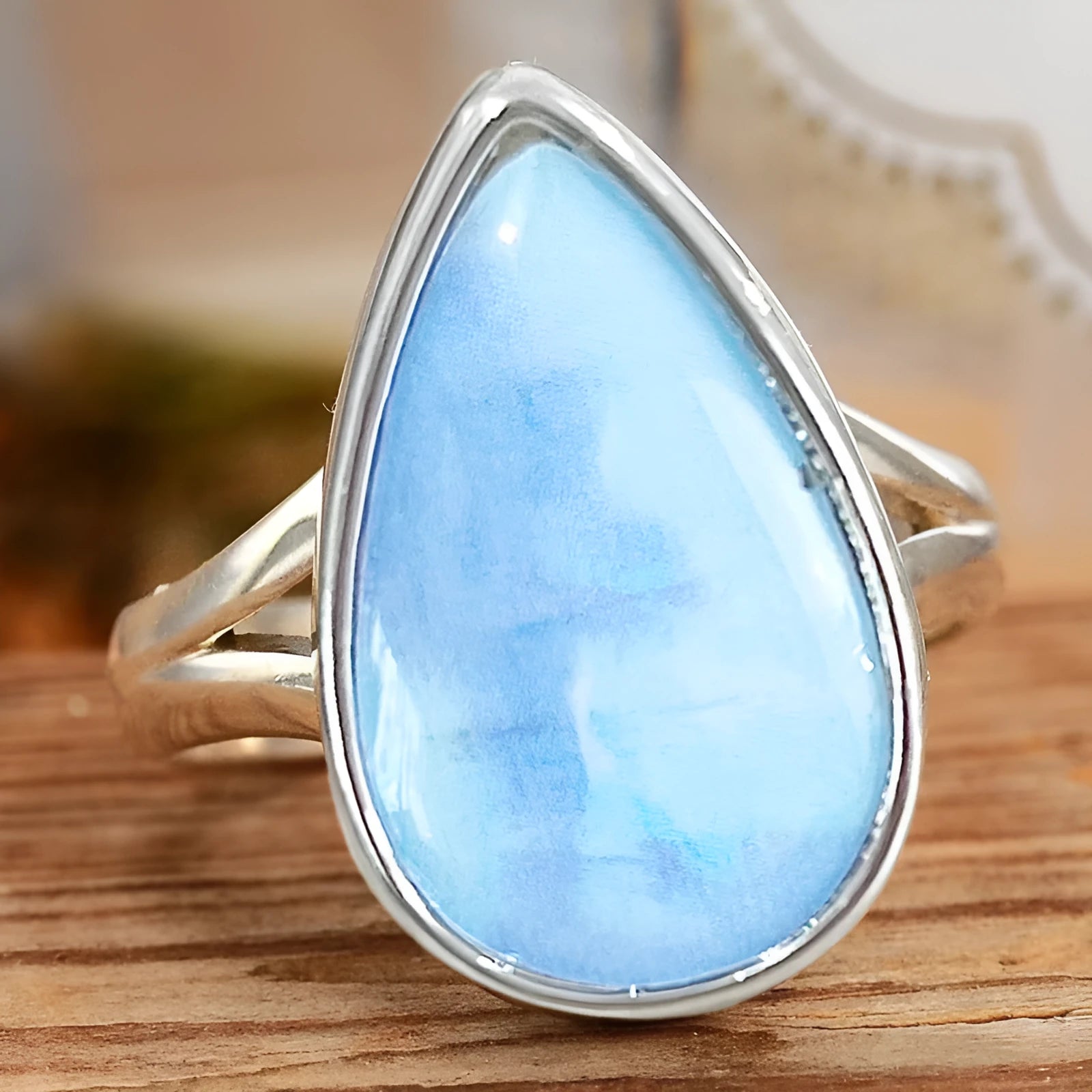 Women's copper drop-shaped geometric ring in electroplated A077 white gold colour, side view on white background