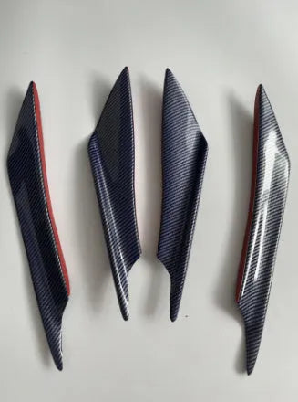 Set of four ABS plastic bumper air knife spoilers in a carbon fibre finish for car modification.
