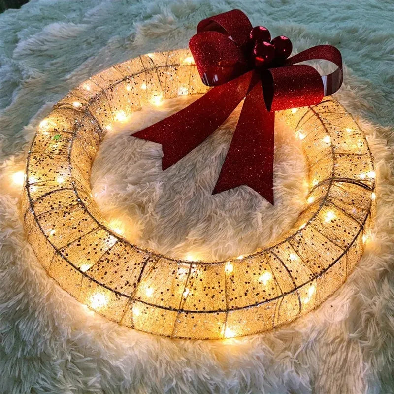 50cm gold green tinsel Christmas garland with LED lights and big bowknot on a wooden door