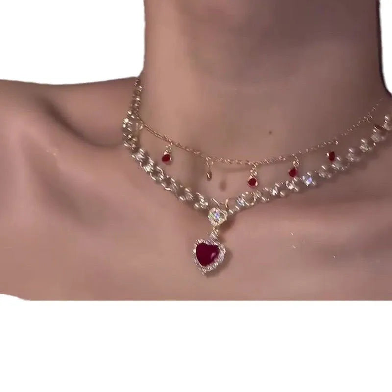 Red double layer necklace with twin chains, a pearl pendant, and a love heart pendant on an adjustable alloy chain.