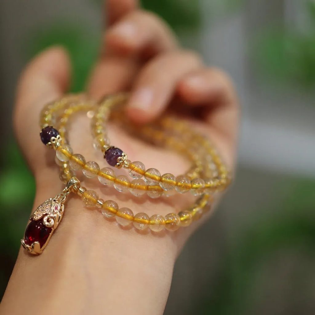 Natural Brazilian rutilated quartz bracelet with Chinese style three gold rings and hanging chopsticks design